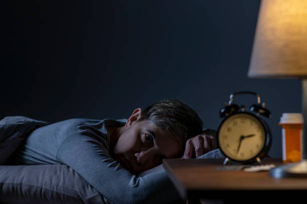 istock Depressed senior woman lying in bed cannot sleep from insomnia 1461951567