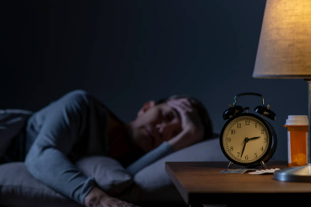 istock Depressed senior woman lying in bed cannot sleep from insomnia 1461951569