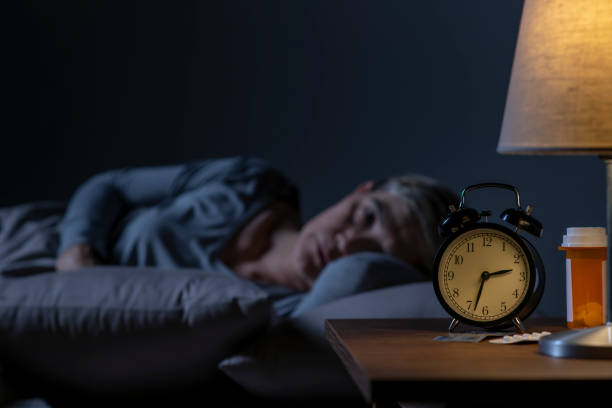 istock Depressed senior woman lying in bed cannot sleep from insomnia 1461951576