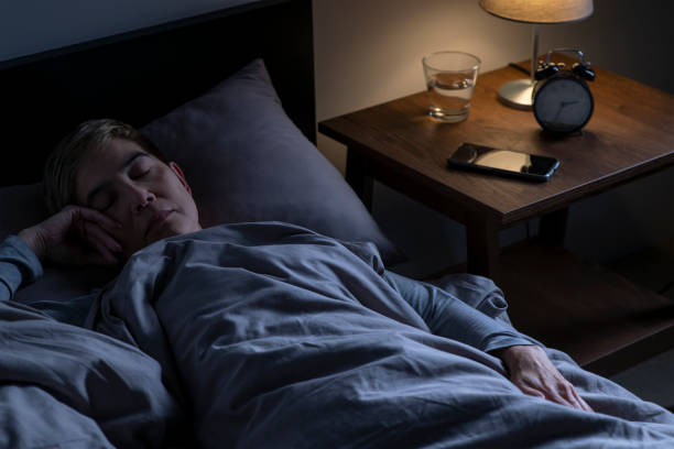 istock Depressed senior woman lying in bed cannot sleep from insomnia 1461952154