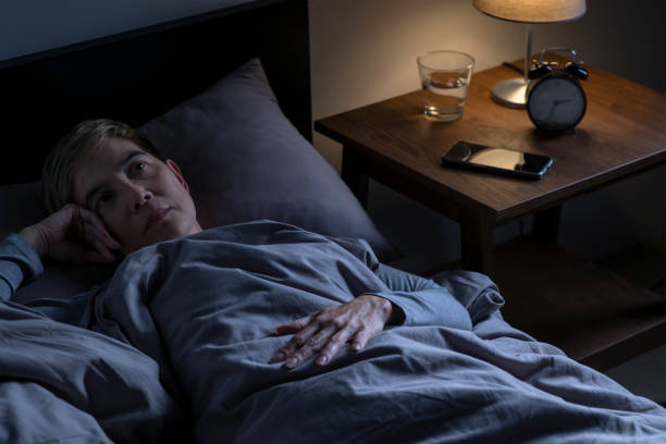 istock Depressed senior woman lying in bed cannot sleep from insomnia 1461952166