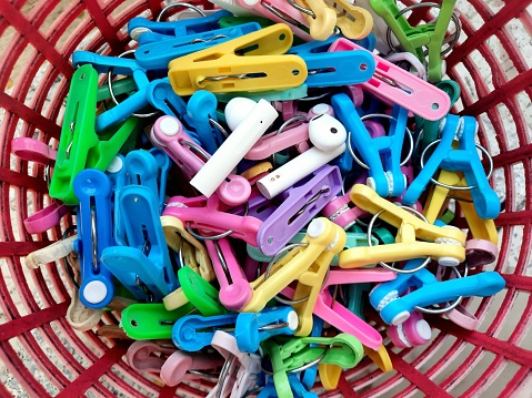 Wireless Headphones hiding among Clothespins.