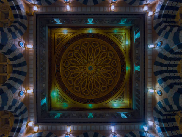 The Prophet's Mosque, the Prophet's Mosque, or the Prophet's Mosque is one of the largest mosques in the world and the second holiest place in Islam (after the Grand Mosque in Mecca). The mosque witnessed many expansions throughout history, so it passed during the era of the Rashidun Caliphs and the Umayyad state, then the Abbasids and the Ottomans, and finally during the era of the Saudi state, where its largest expansions occurred in 1994. The mosque is considered the first place in the Arabian Peninsula to be lit using electric lamps in 1327 AH corresponding to 1909 AD .