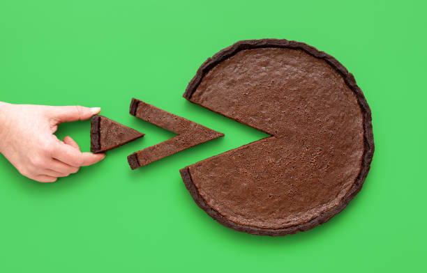Pie chart concept, woman taking a small slice of chocolate tart stock photo