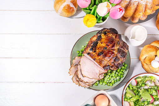 Traditional glazed baked pork. Homemade roasted ham, on festive served Easter lunch or brunch table