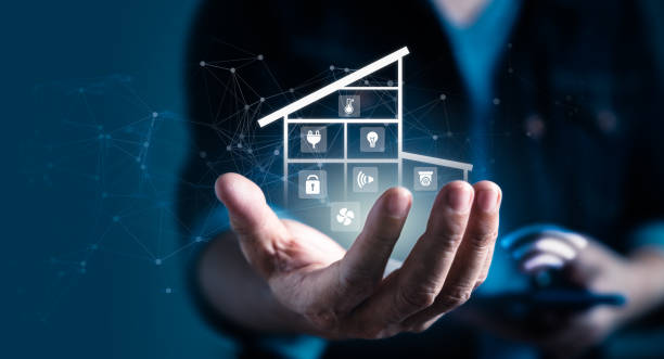 istock Man holding virtual application and icons as house remote control assistant 1462018996