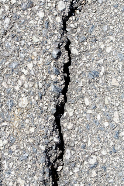 istock Cracked, broken and damaged asphalt road detail 1462021845