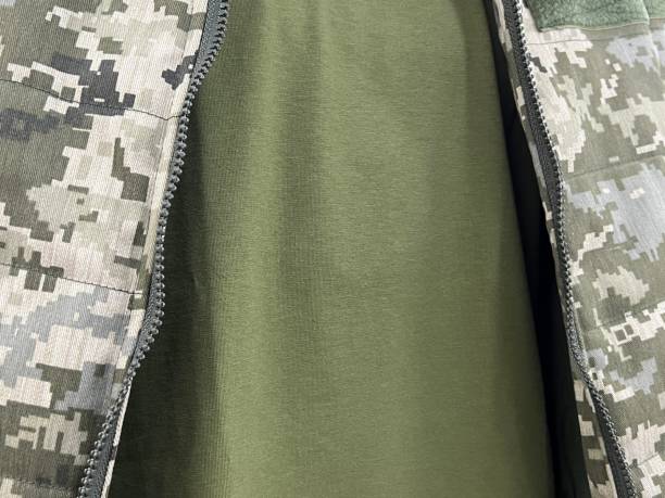istock Military uniform fabric with pixeled pattern and khaki T-shirt. 1462022124