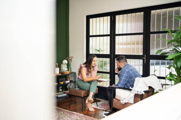 istock Two interior designers discussing new project details on digital tablet 1462023133