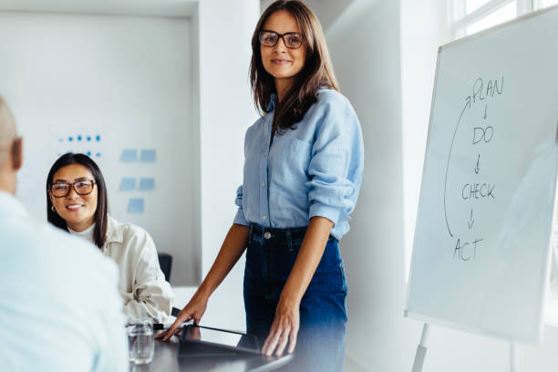 istock Female team leader giving a presentation in an office 1462024120