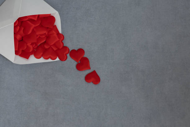 istock An image of sending and receiving love with a flat composition white envelope and heart. 1462024645