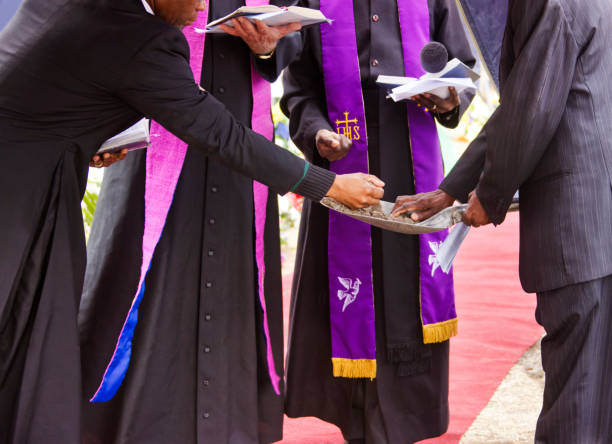 istock group of priests reading prayers at a funeral 1462024788