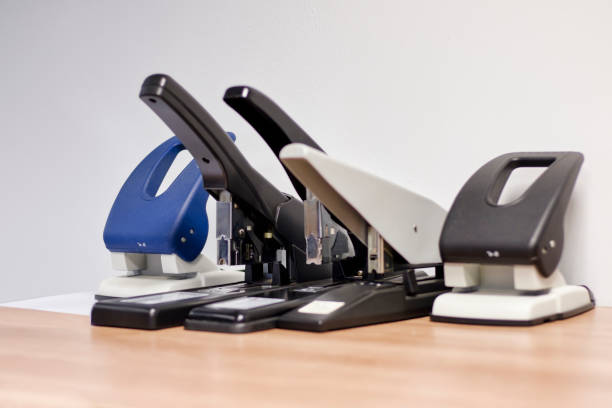 paper hole puncher and stapler classic paper hole puncher and stapler classic stationary in an office hole puncher stock pictures, royalty-free photos & images