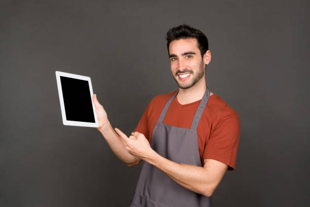 istock Worker pointing black the screen of a tablet 1462032049