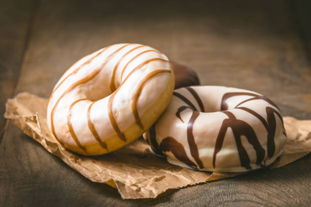 istock White and dark chocolate donuts on a dark wooden table, copy space 1462035478