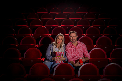 Theatre going couple at the cinema together