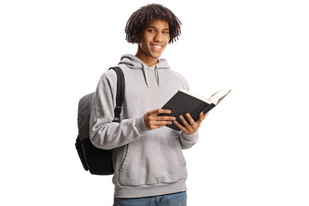 istock Male african american student standing and reading a book 1462045226