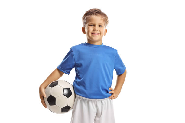 istock Boy in a football jersey posing with a ball 1462052884