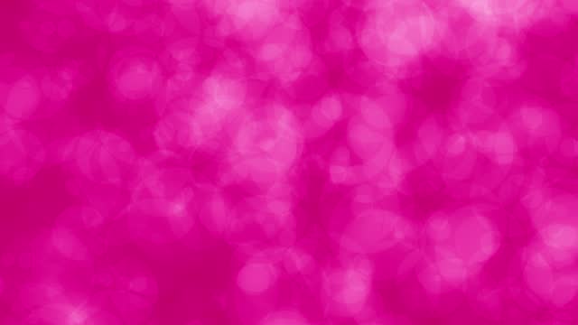 Bokeh orbs foating into a solid pink background