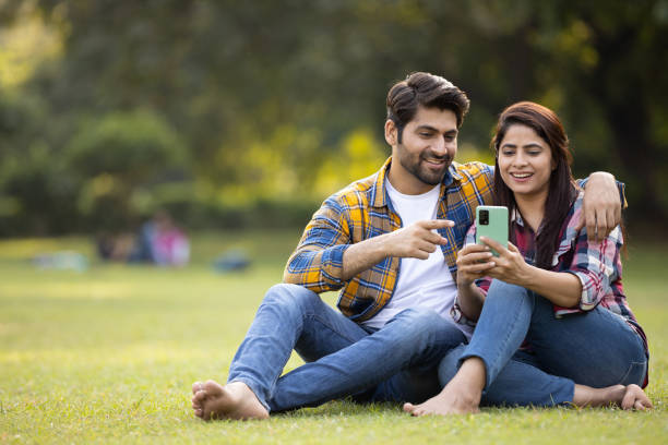 istock Young man pointing toward mobile screen holds by young woman. Stock photo 1462062607