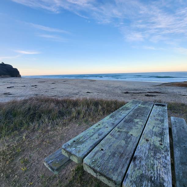 istock Old, grunge wooden bench by the beach at sunset 1462063668