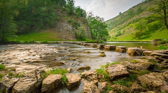 A beautiful view of the Peak District National Park with step stones in the river