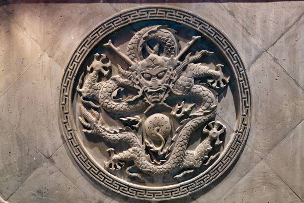 istock A traditional Chinese statue on a rough stone wall, framed in a circle, illuminated by light 1462064897