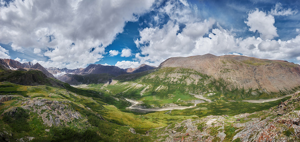 Panorama Mountain valley of Altai mountains, fabulous Alpine landscape of the peaks of the ridges, amazing views of the valley in summer. Hike