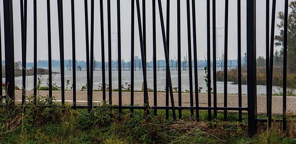 The coastline from behind a metal fence