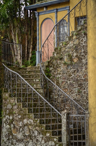 A vertical shot of a decorative handrail and stone stairs outdoors