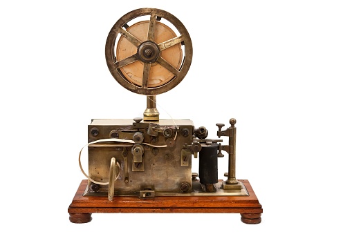 A closeup of a Telegraph machine with a white background