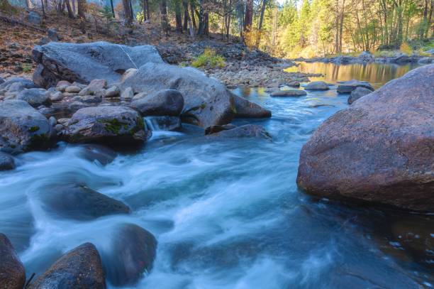 istock Rushing river water surrounded by large rocks and boulders 1462083285