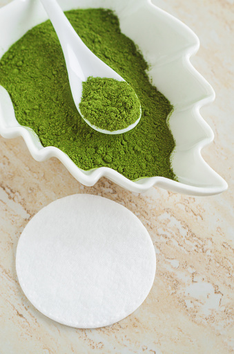 istock White porcelain bowl with matcha green tea powder (henna, seaweed) and cotton pad. Natural beauty treatment and spa. Homemade matcha mask recipe. Selective focus. 1462085197