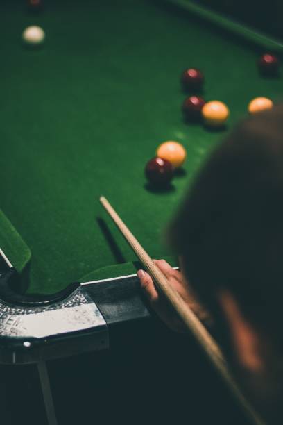 istock Vertical shot of a man holding a cue and getting ready to hit 1462089696