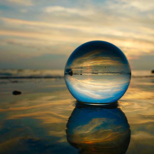 istock Crystal ball on the beach with reflections 1462091061