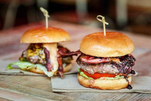 istock Fresh flame grilled bacon cheeseburgers on wooden table 1462094494