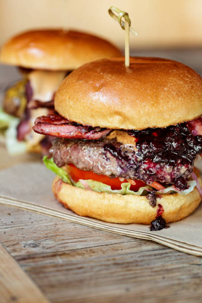 istock Fresh flame grilled bacon cheeseburgers on wooden table 1462094495
