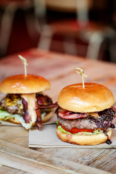 istock Fresh flame grilled bacon cheeseburgers on wooden table 1462094499
