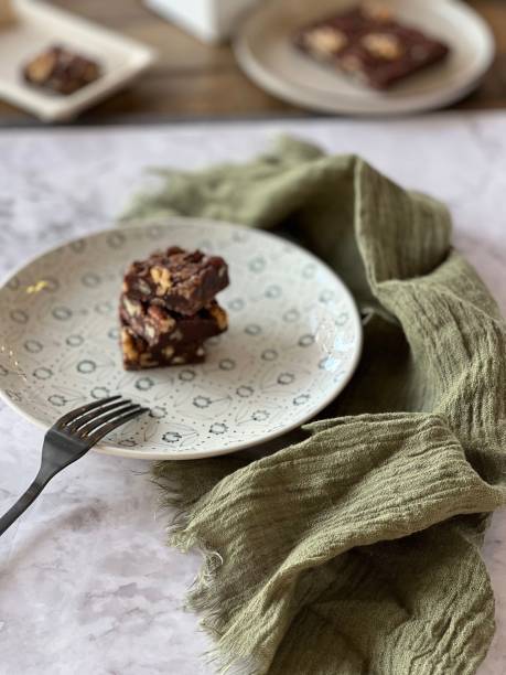 istock Vertical closeup of brownies with walnuts on a plate. 1462098572
