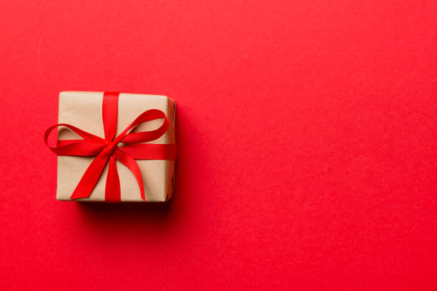 istock Valentine day composition: red gift box with bow and heart. Christmas present. View from above. Space for text. Holday greeting card 1462099889