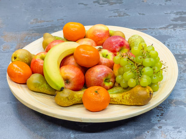 istock fruits plate with fresh grapes, pears, apples 1462100475
