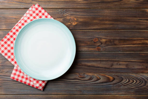 istock Top view on colored background empty round blue plate on tablecloth for food. Empty dish on napkin with space for your design 1462100481