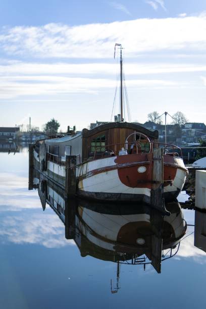 istock Vertical shot of a boat in the harbor reflected on the water's surface. 1462102624