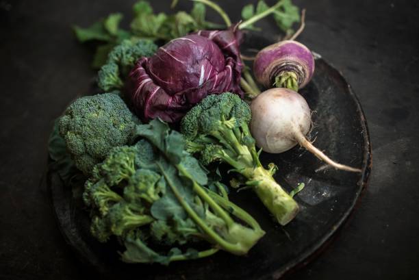 istock Closeup of cabbage and broccoli in a black plate, dark background 1462102643