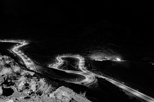 An aerial greyscale night view of the Al-Hada Road Taif