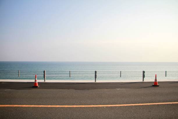 istock Traffic cones on a freshly repaired seaside road on a sunny day 1462108571