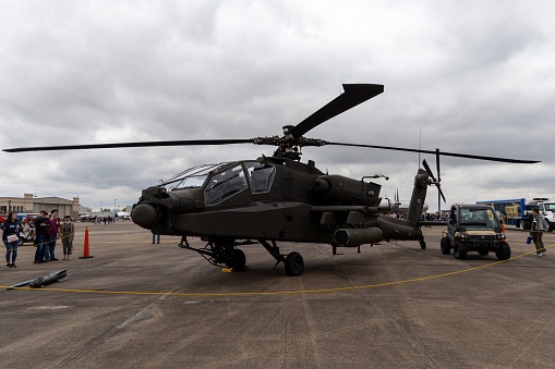 Military figher airplane landing on an airport runway.