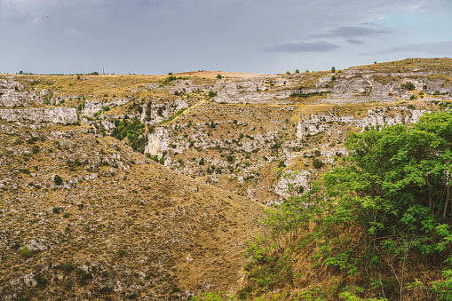 Looking at Murgia National Park with prehistoric caves and rupestrian churches near the ancient town of Matera, in southern Italy. Matera has gained international fame for its ancient town, the \