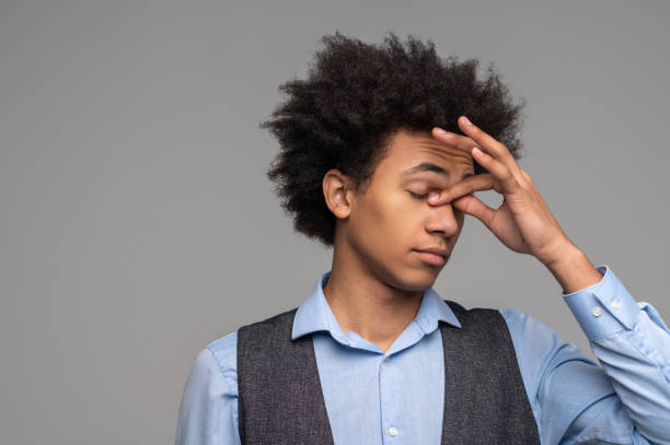 istock Dark-haired young man looking tired and stressed 1462115429