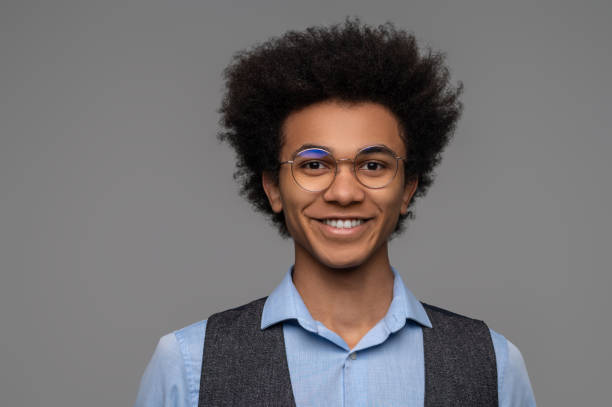istock Dark-haired young man in eyeglasses looking happy 1462116052
